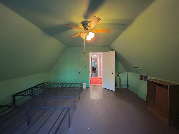 a bedroom with a bed chairs and a chandelier