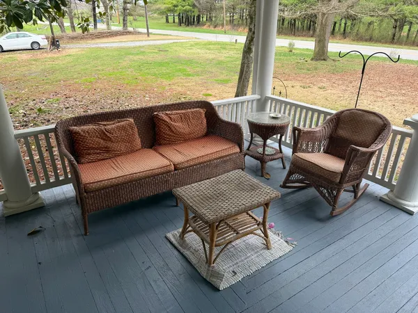 a view of a patio with lawn chairs floor to ceiling window and wooden floor