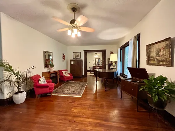 a living room with furniture and wooden floor