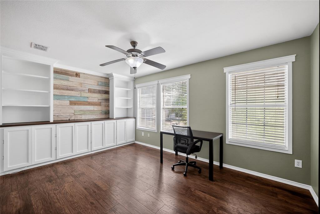 9633 Anns Way Plano, TX 75025 - Photo 22 of 37 a view of an empty room with a window and wooden floor