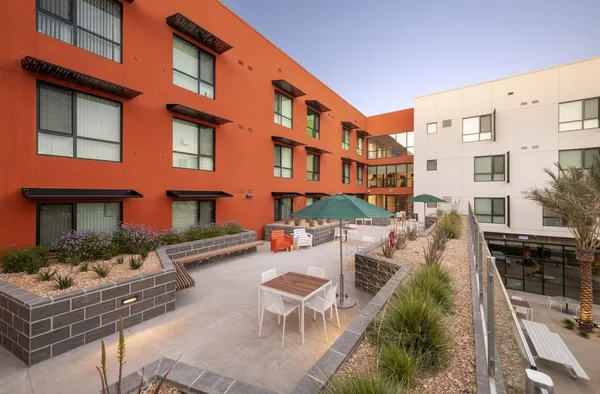 a view of a building with outdoor seating space