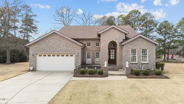 a front view of a house with a yard and garage