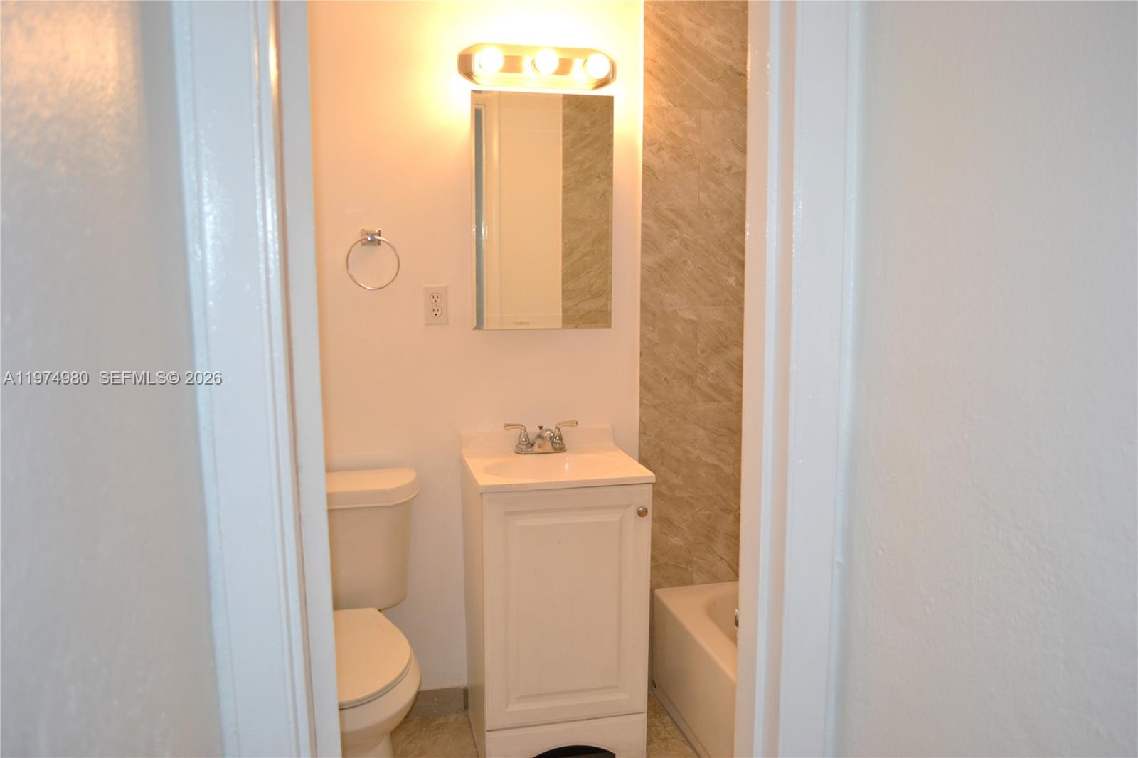 1035 Southwest 4th Street, Unit 2 Miami, FL 33130 - Photo 9 of 11 a bathroom with a toilet a sink and a mirror
