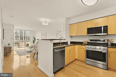 a kitchen with a stove a sink and a microwave