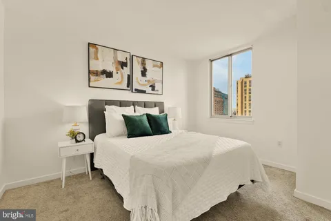 a bedroom with a bed and a painting