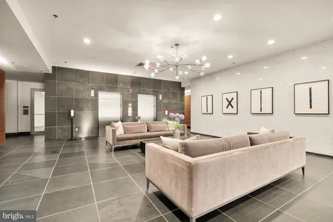 a living room with furniture and a chandelier