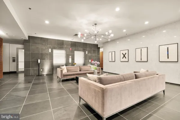 a living room with furniture and a chandelier