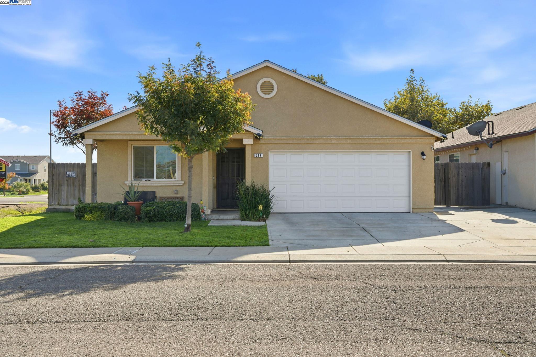 296 Dena Court Merced, CA 95341 - Photo 1 of 1 a front view of a house with a yard and garage