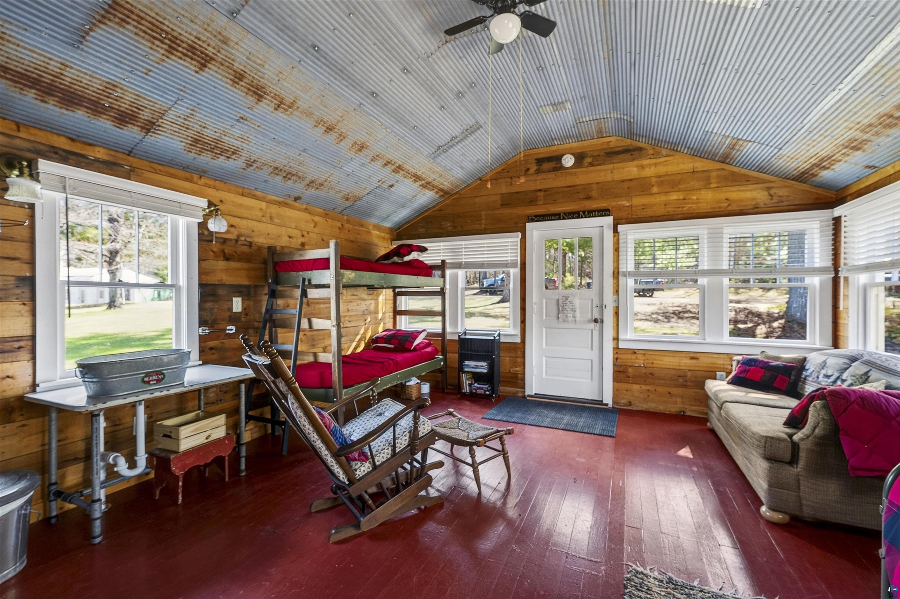 13885 Park Road Brule, WI 54820 - Photo 33 of 41 Interior space featuring wood-finish walls and a corrugated metal ceiling