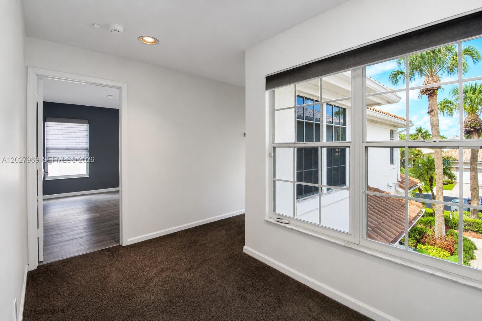 6646 Northwest 25th Terrace Boca Raton, FL 33496 - Photo 23 of 48 wooden floor in an empty room with a window