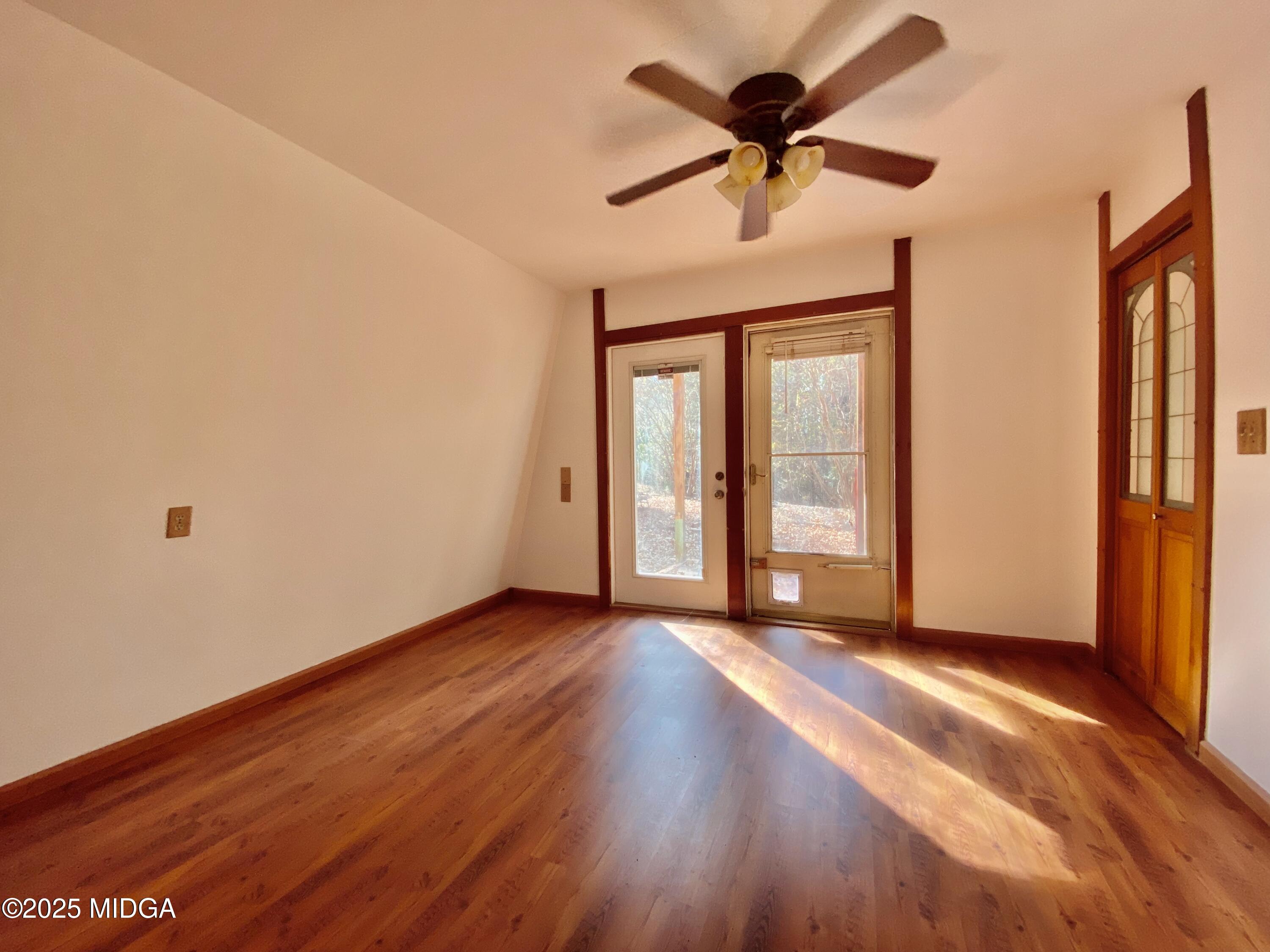 231 West Seminole Drive Byron, GA 31008 - Photo 8 of 38 a view of an empty room with a window and wooden floor
