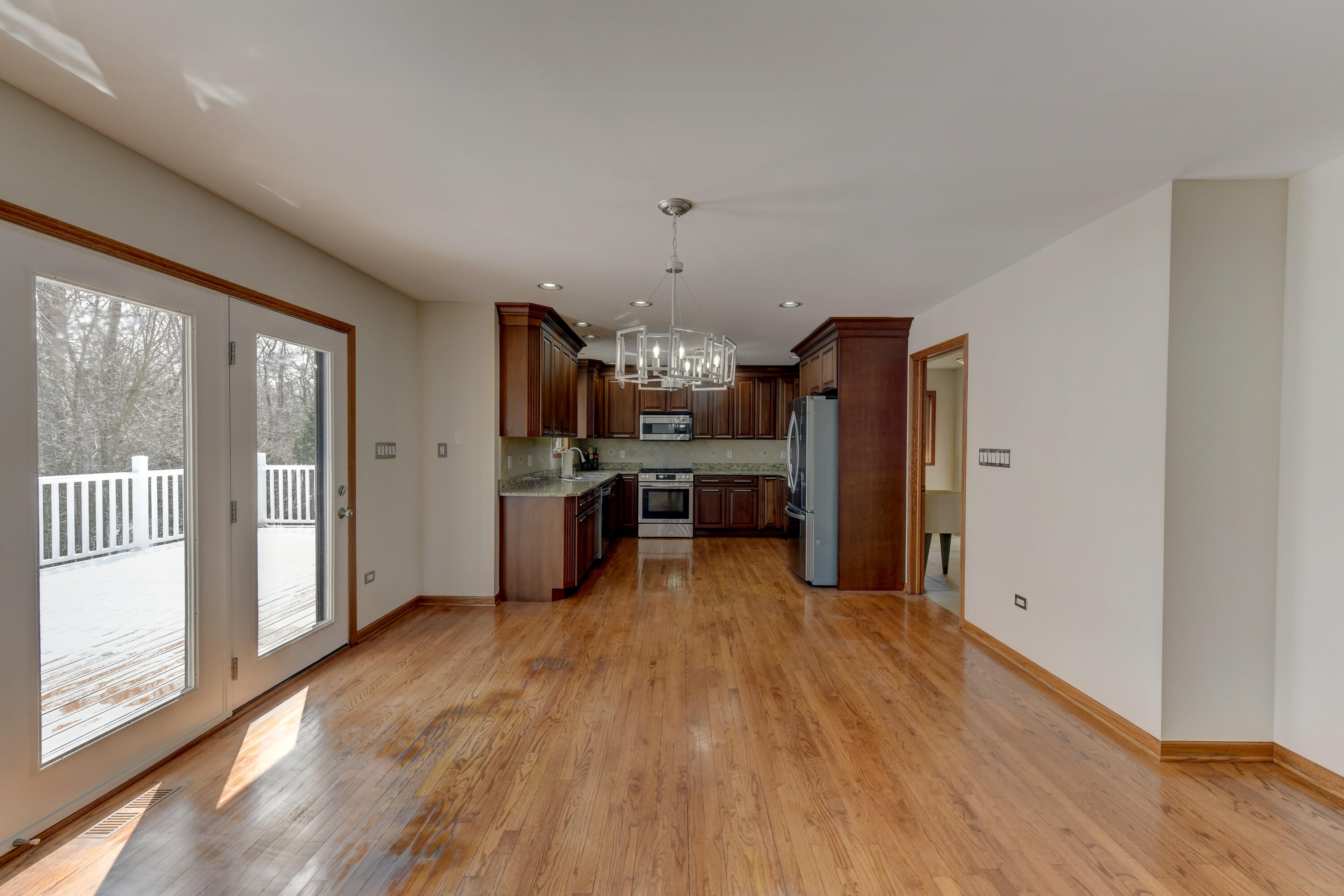 9575 Calumet Street Dyer, IN 46311 - Photo 27 of 53 a kitchen with stainless steel appliances kitchen island wooden floors stove and refrigerator