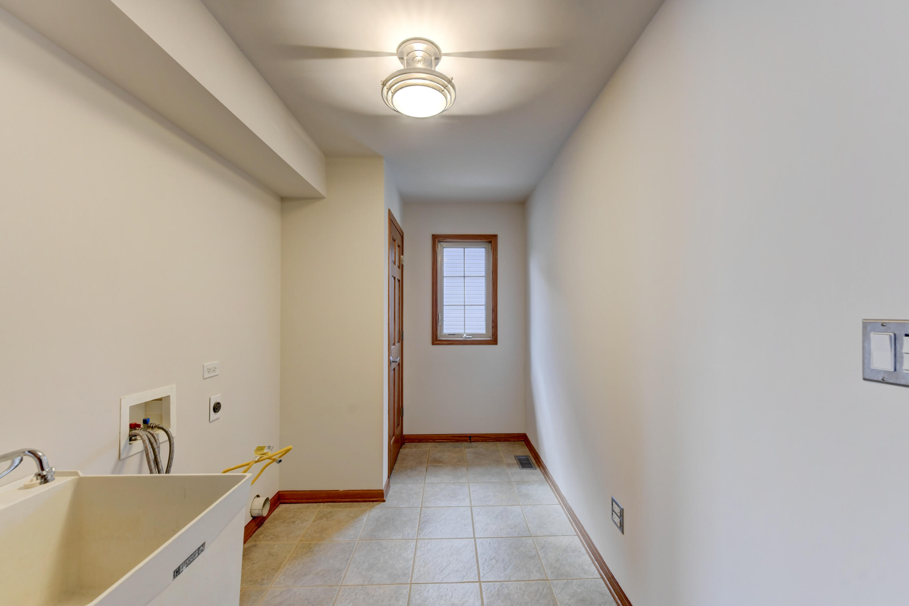 9575 Calumet Street Dyer, IN 46311 - Photo 38 of 53 a view of a hallway with a sink and chandelier