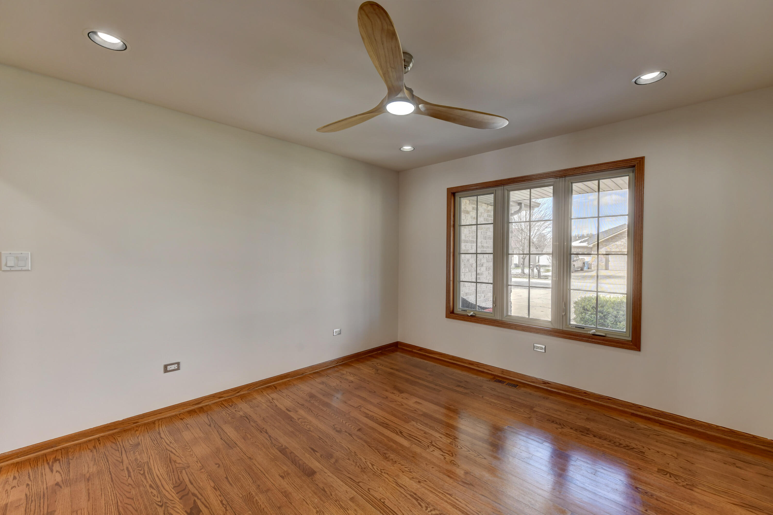 9575 Calumet Street Dyer, IN 46311 - Photo 4 of 53 a view of an empty room with wooden floor and a window