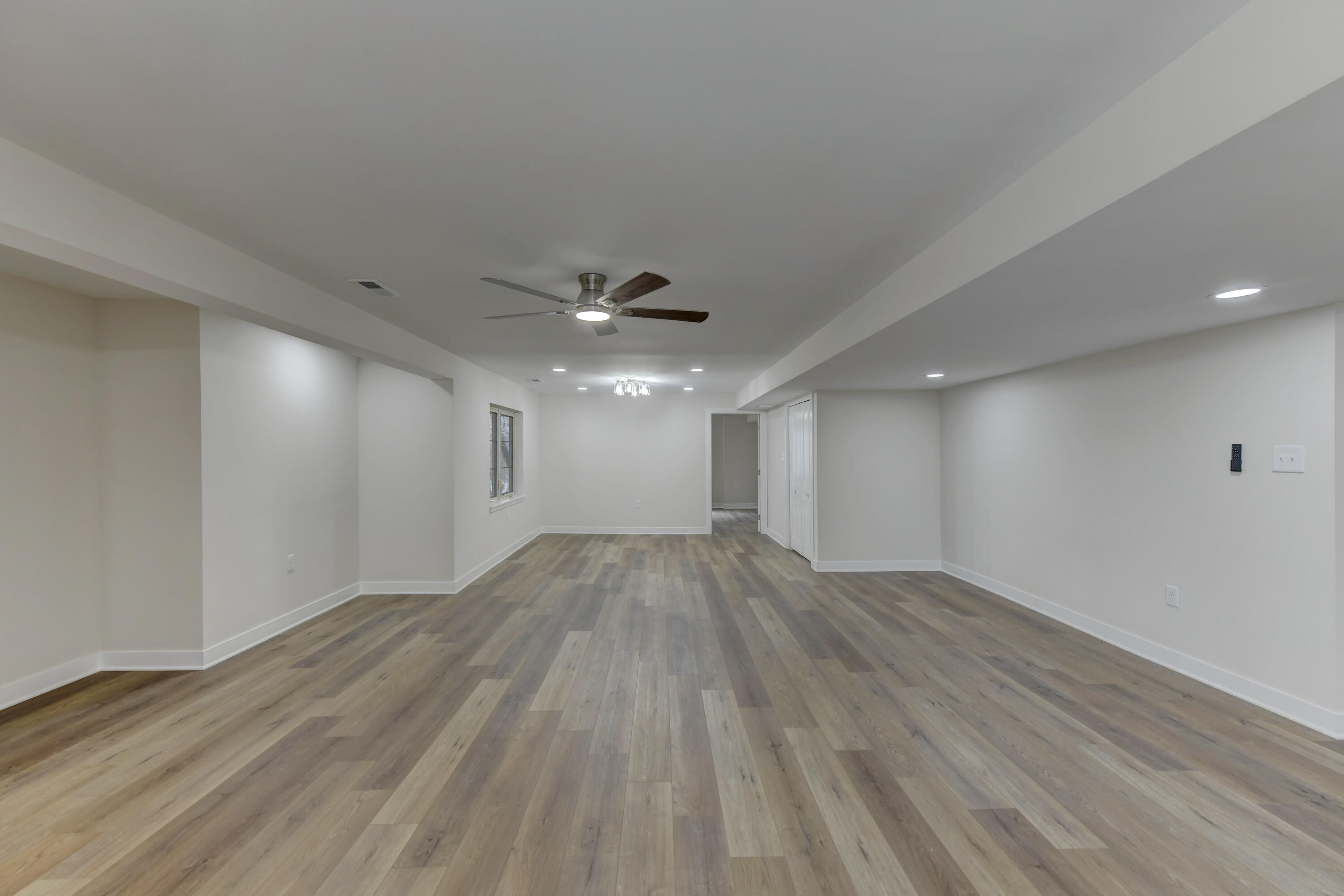 9575 Calumet Street Dyer, IN 46311 - Photo 46 of 53 an empty room with wooden floor chandelier fan and windows