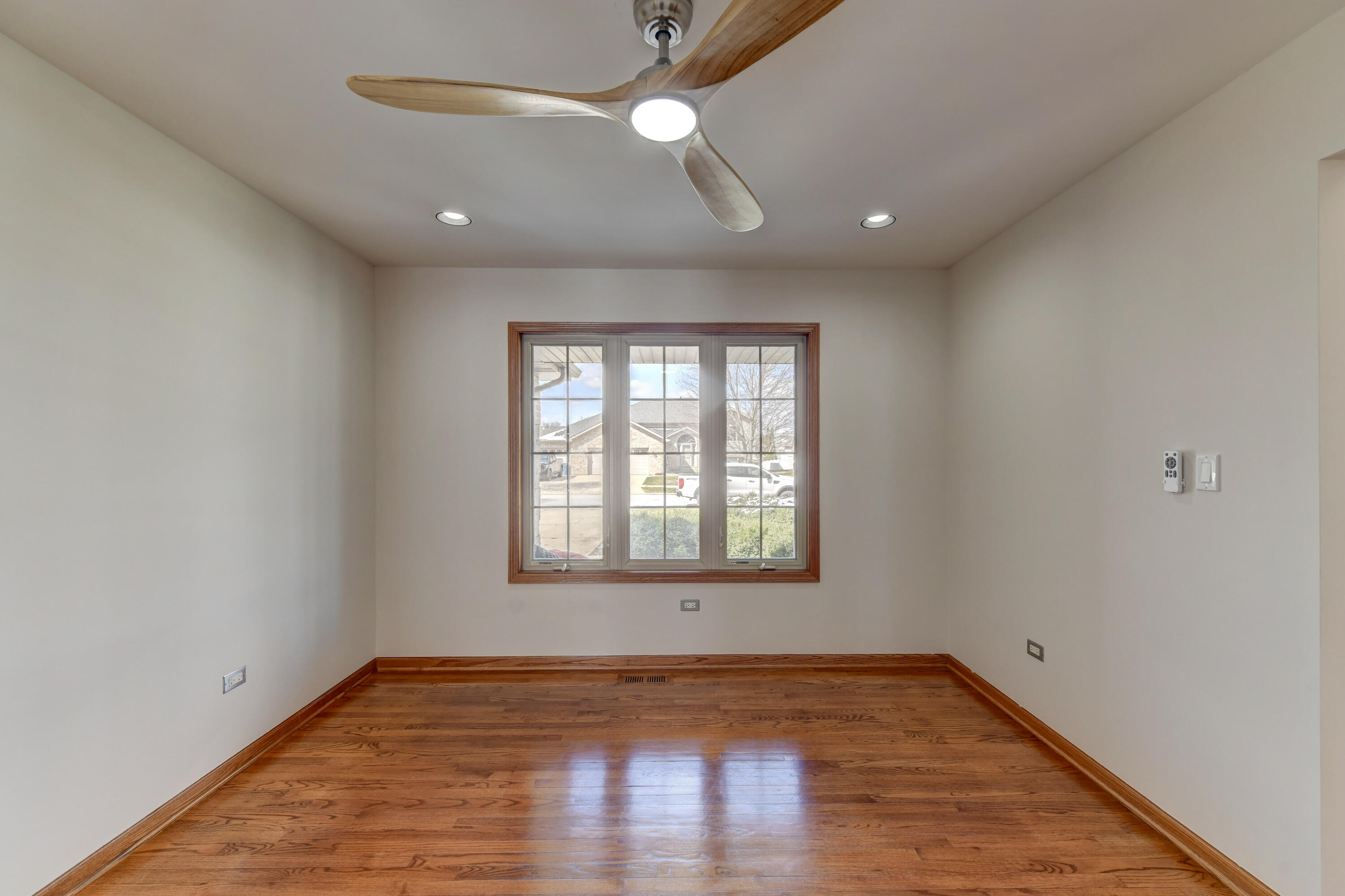 9575 Calumet Street Dyer, IN 46311 - Photo 6 of 53 a view of empty room with wooden floor and fan