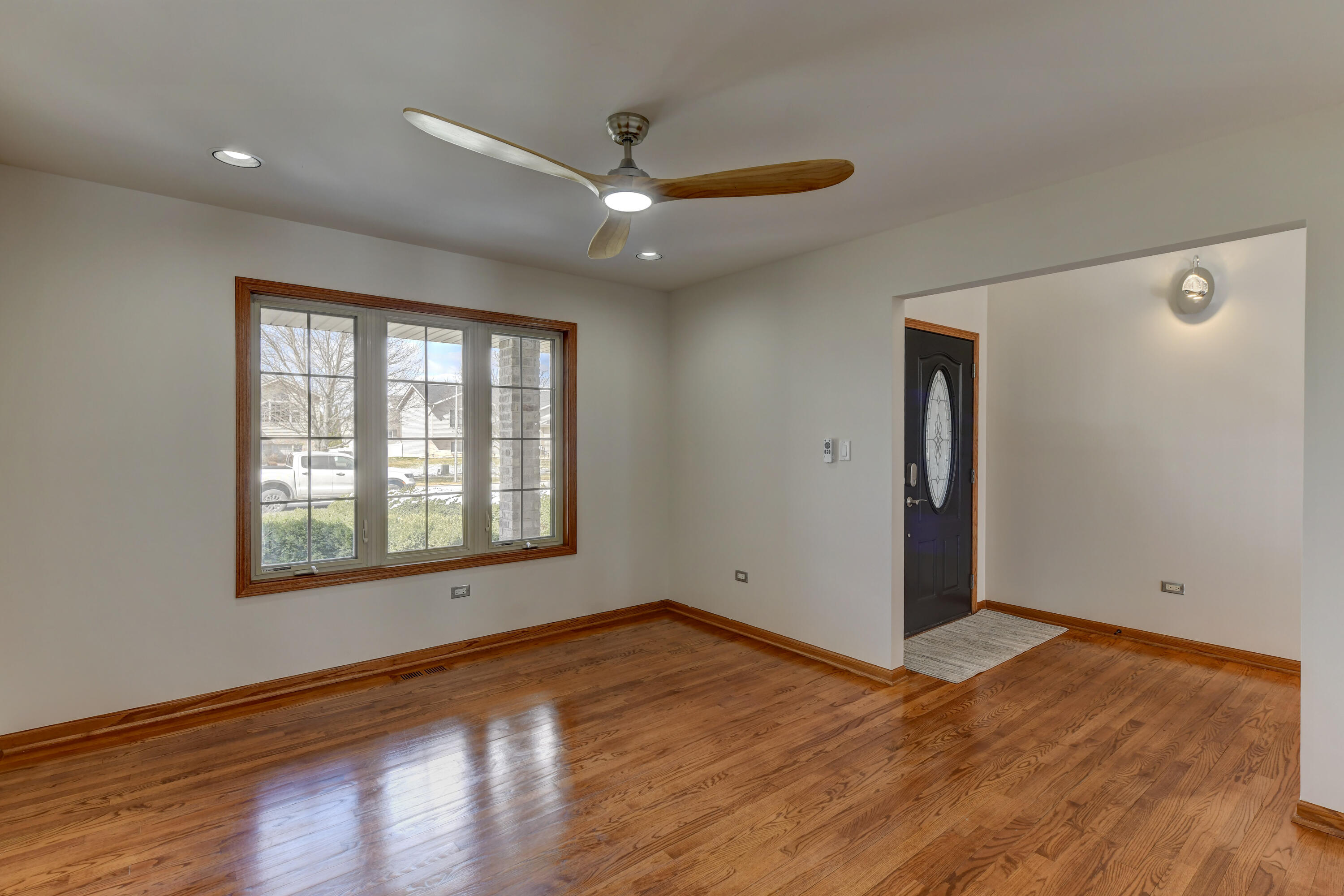 9575 Calumet Street Dyer, IN 46311 - Photo 7 of 53 a view of an empty room with wooden floor and a window