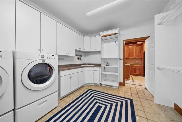 a kitchen with a refrigerator sink and cabinets