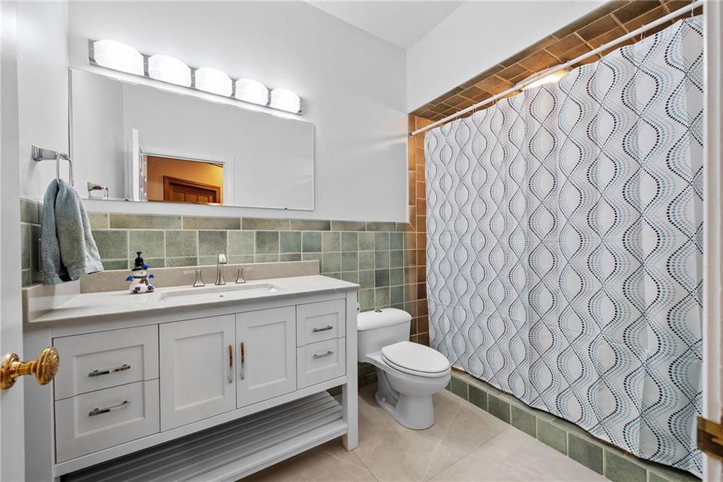 1351 Lindsey Road New Castle, PA 16105 - Photo 20 of 49 a bathroom with a toilet sink and mirror