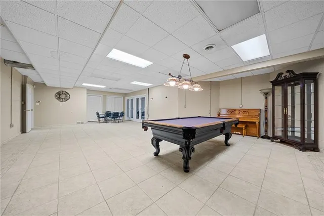 a spacious bedroom with a bed and a chandelier