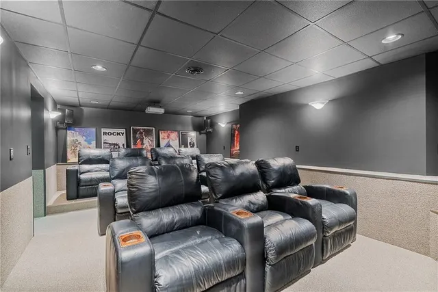 a media room with lots of chairs and a projector