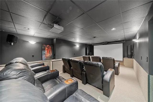 a media room with lots of chairs and a projector screen