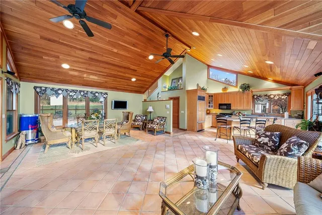 a view of a patio with table and chairs potted plants with wooden floor