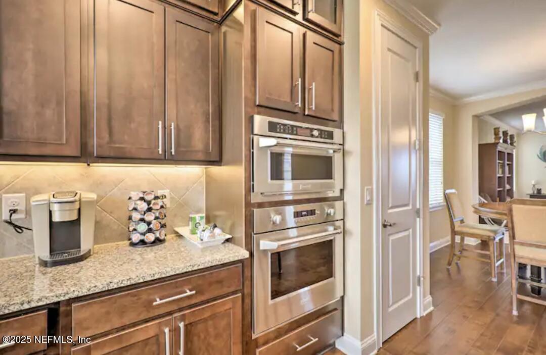 168 Lawn Avenue St. Augustine, FL 32084 - Photo 15 of 36 a kitchen with stainless steel appliances granite countertop a refrigerator and cabinets