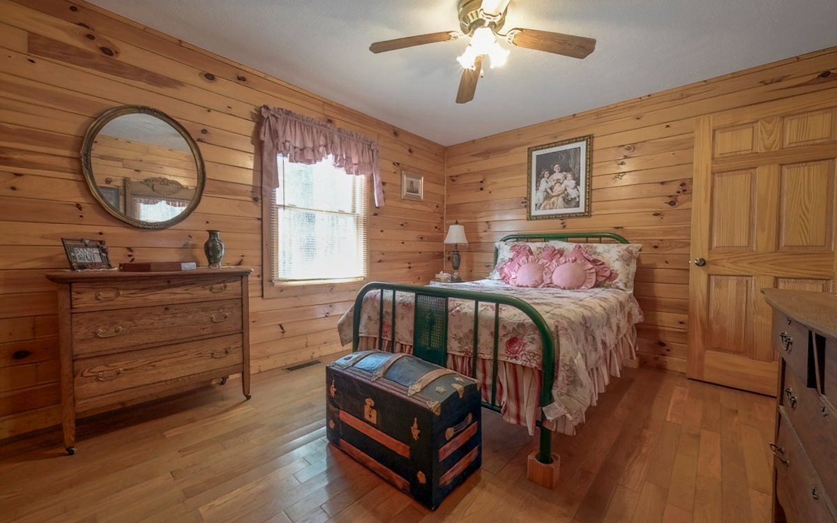 197 Macedonia Church Road Blue Ridge, GA 30513 - Photo 22 of 29 a bedroom with a bed and a chandelier