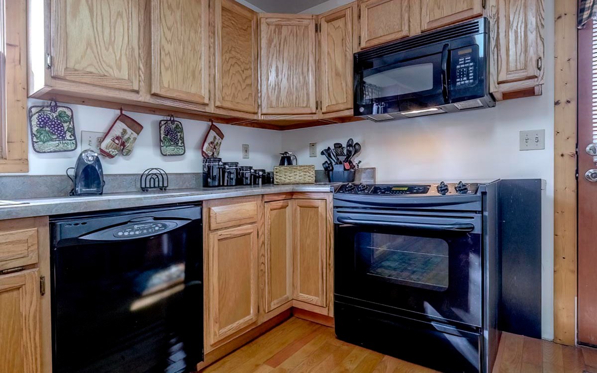197 Macedonia Church Road Blue Ridge, GA 30513 - Photo 10 of 29 a kitchen with stainless steel appliances granite countertop a stove microwave and oven