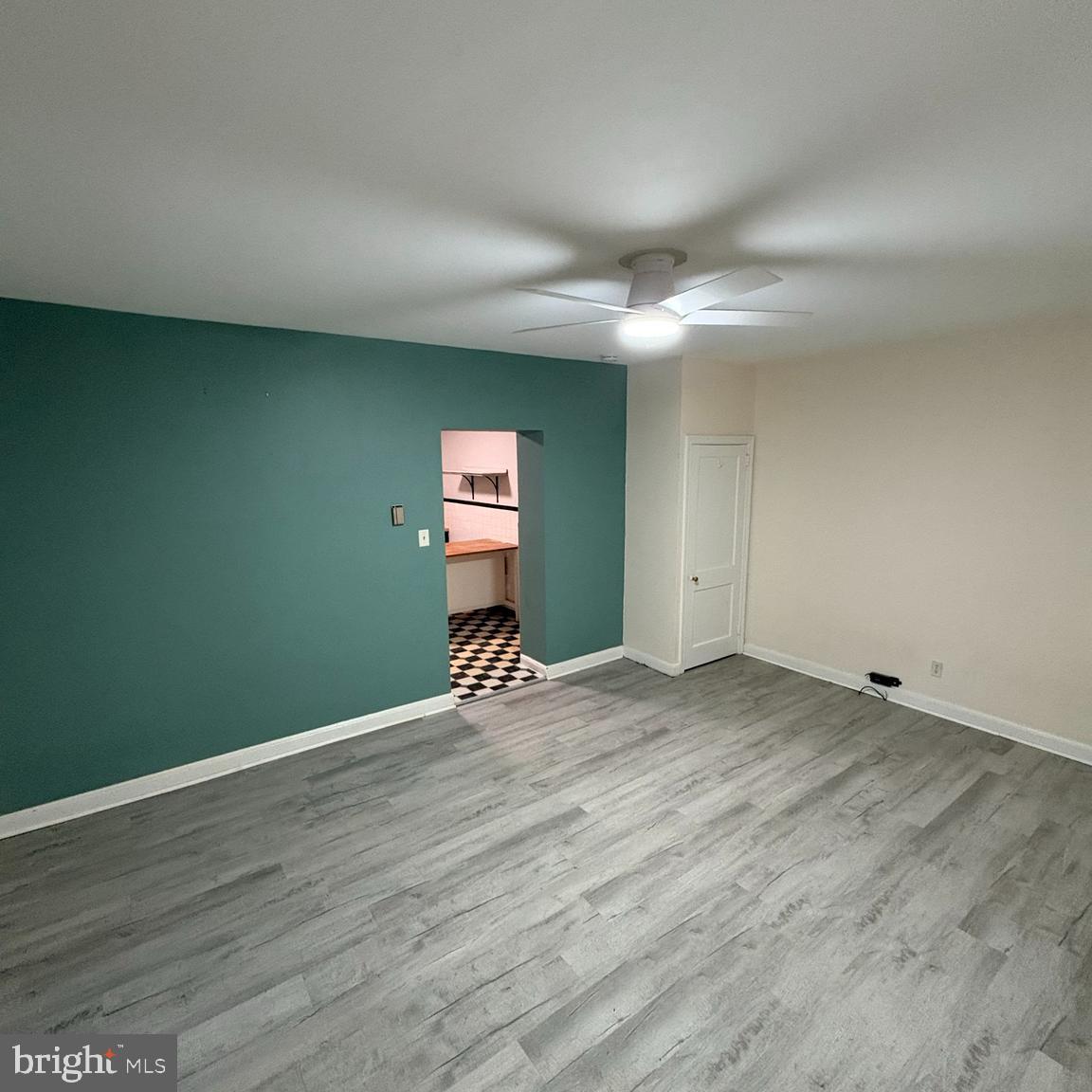 373 East Butler Avenue, Unit A Ambler, PA 19002 - Photo 4 of 14 an empty room with wooden floor cabinet and windows