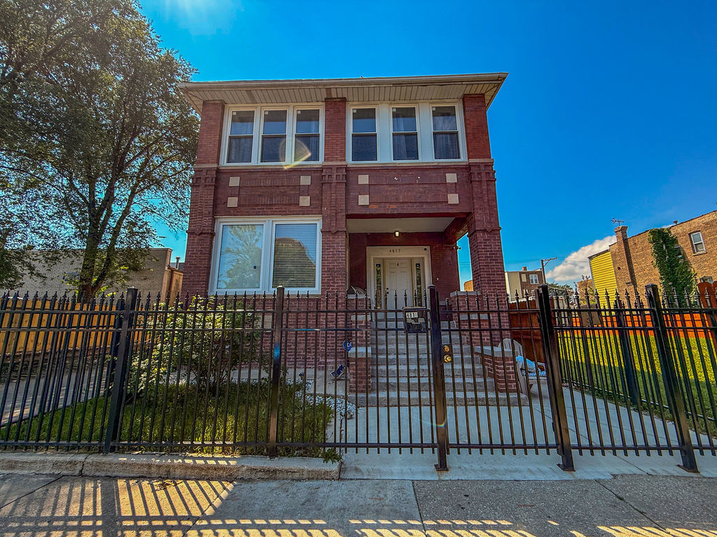 4817 West Jackson Boulevard, Unit 2 Chicago, IL 60644 - Photo 1 of 20 a front view of a house with a iron gate