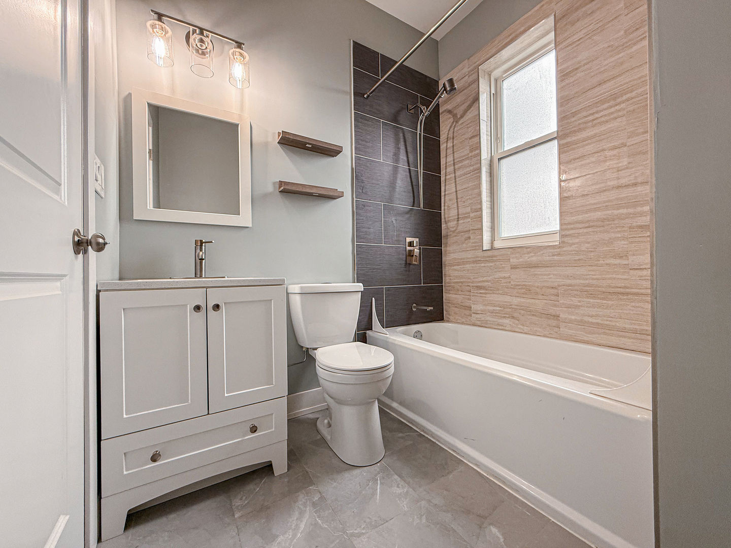 4817 West Jackson Boulevard, Unit 2 Chicago, IL 60644 - Photo 11 of 20 a bathroom with a toilet sink and bathtub