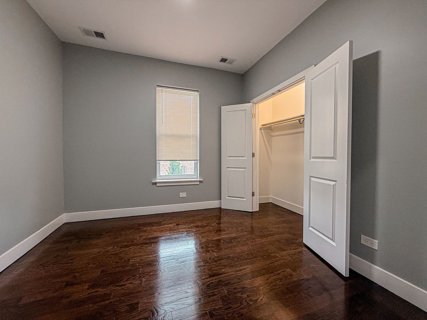 4817 West Jackson Boulevard, Unit 2 Chicago, IL 60644 - Photo 16 of 20 an empty room with wooden floor and windows