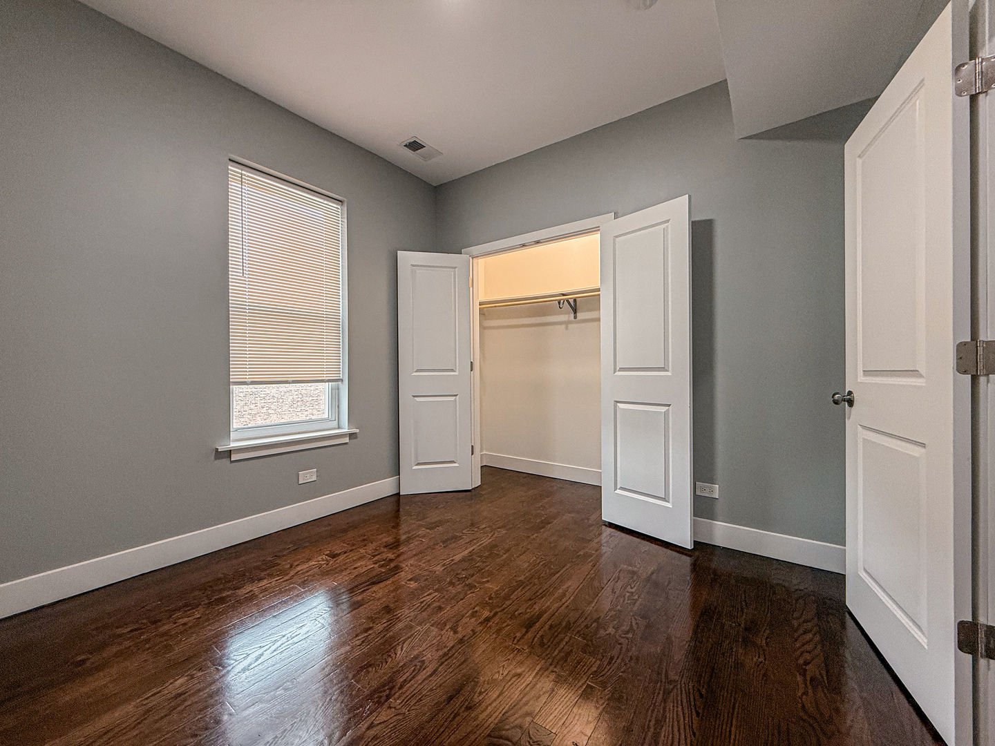 4817 West Jackson Boulevard, Unit 2 Chicago, IL 60644 - Photo 17 of 20 an empty room with wooden floor and windows