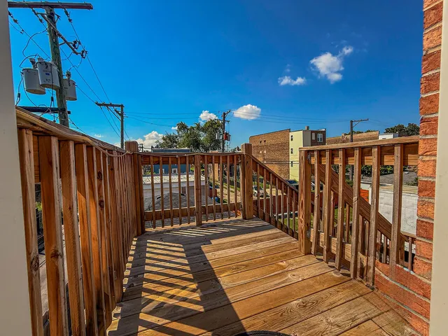 a view of a balcony with wooden floor