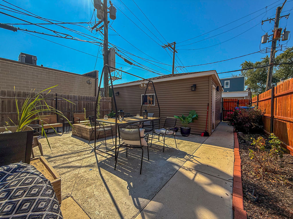 4817 West Jackson Boulevard, Unit 2 Chicago, IL 60644 - Photo 20 of 20 a view of a patio with table and chairs potted plants
