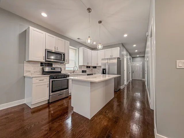 a kitchen with a sink stainless steel appliances and cabinets