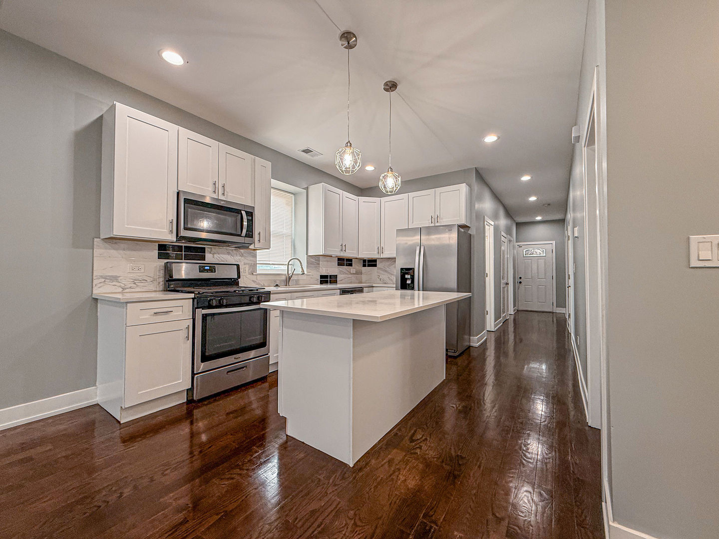 4817 West Jackson Boulevard, Unit 2 Chicago, IL 60644 - Photo 2 of 20 a kitchen with a sink stainless steel appliances and cabinets