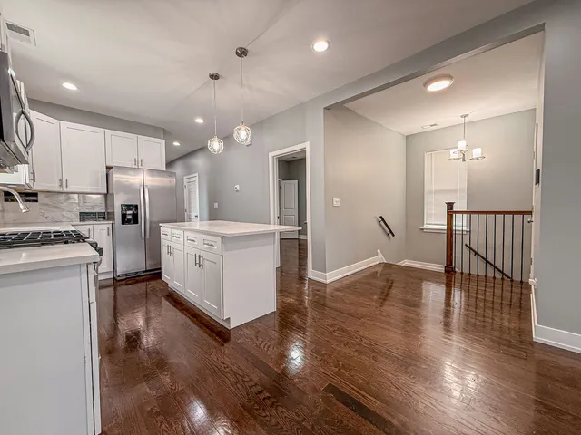 a kitchen with refrigerator and cabinets