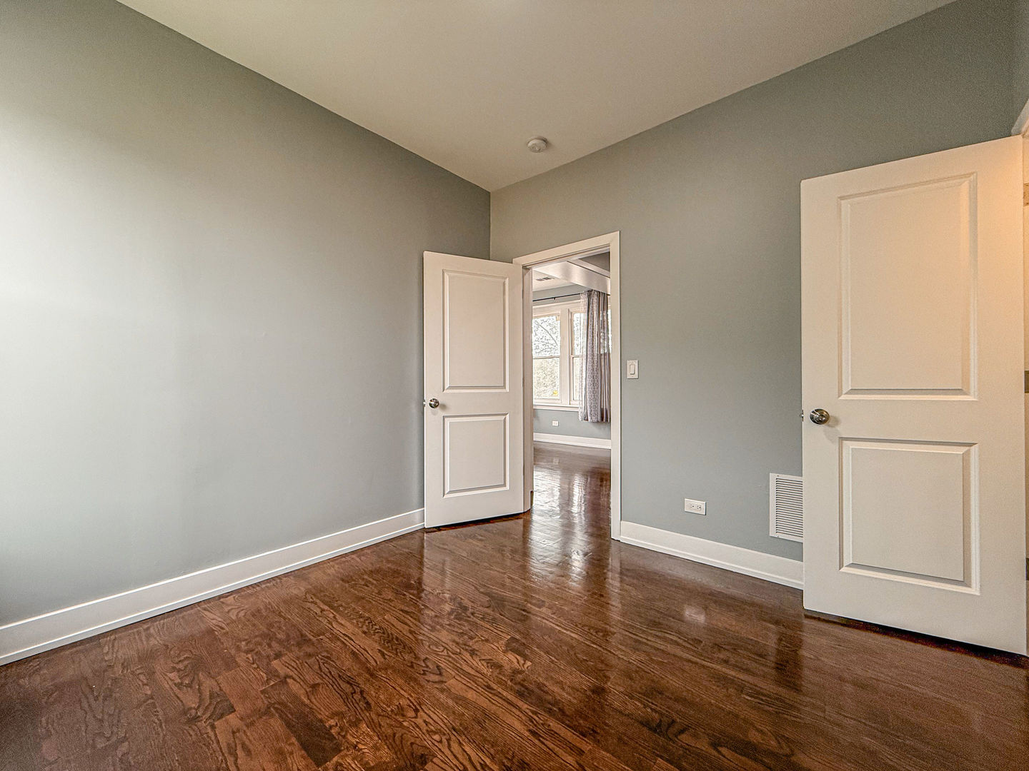 4817 West Jackson Boulevard, Unit 2 Chicago, IL 60644 - Photo 7 of 20 a view of empty room with wooden floor and fan