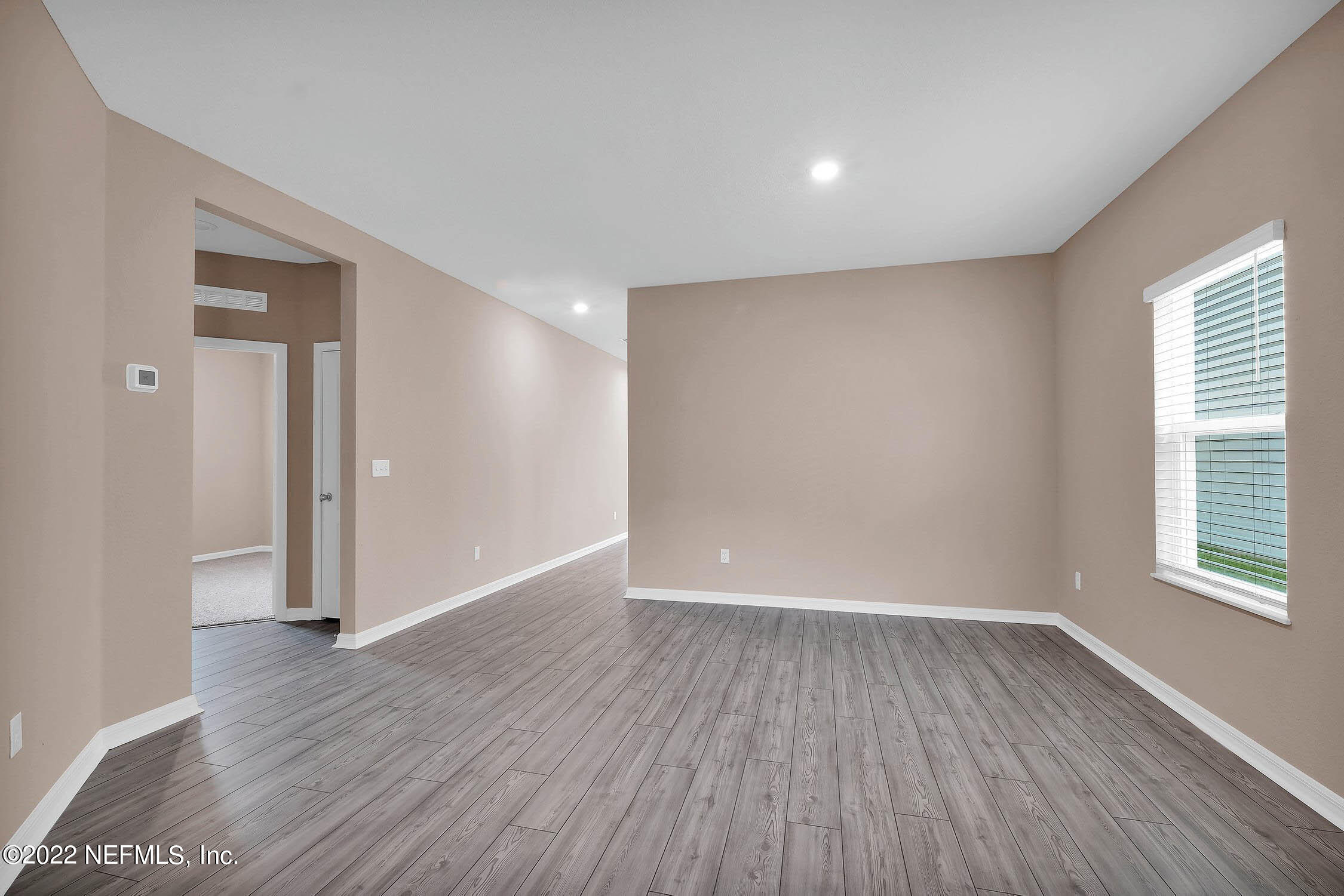 52 Falcon Ridge Road St. Augustine, FL 32084 - Photo 2 of 12 wooden floor in an empty room with a window