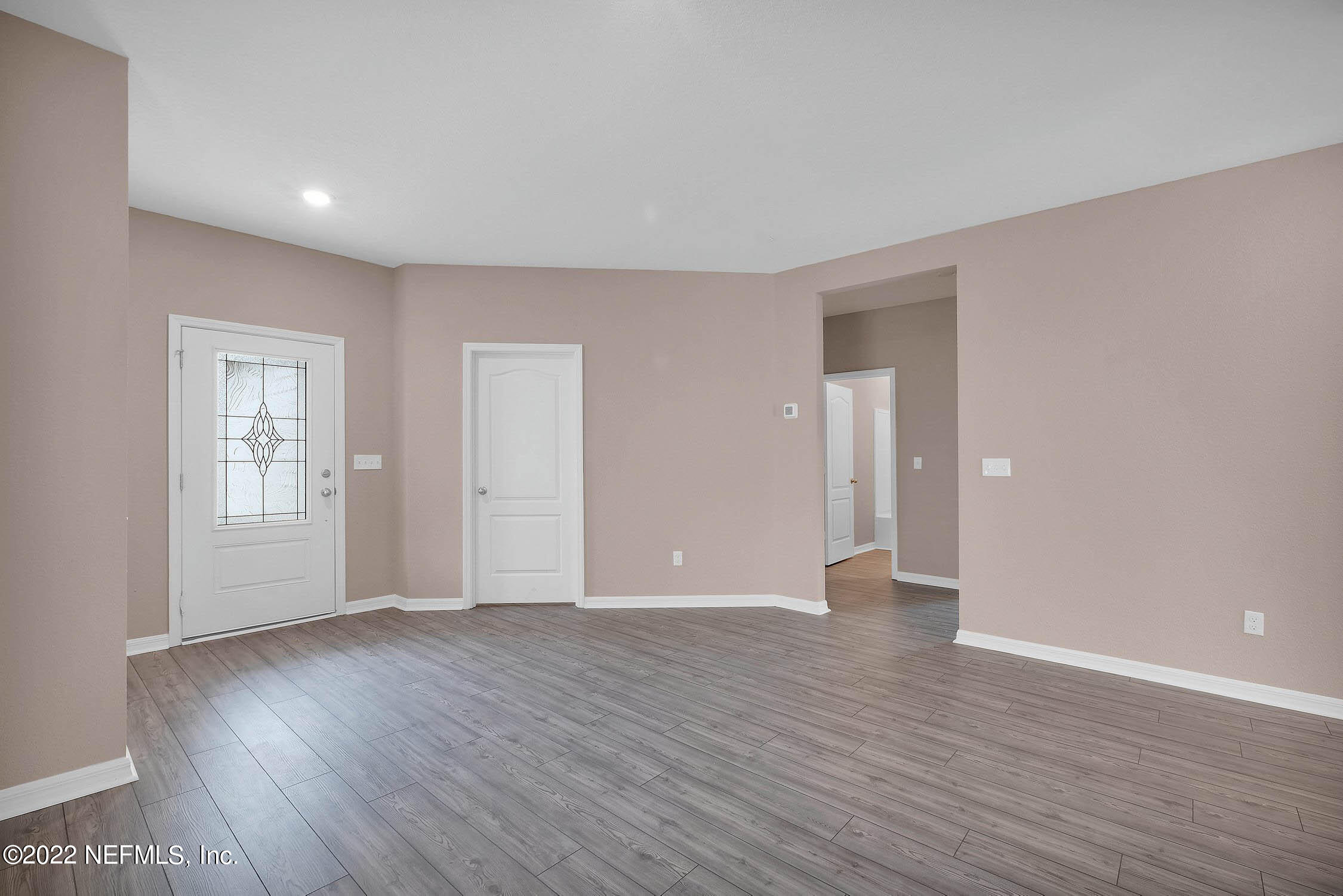 52 Falcon Ridge Road St. Augustine, FL 32084 - Photo 3 of 12 a view of an empty room with wooden floor and a window