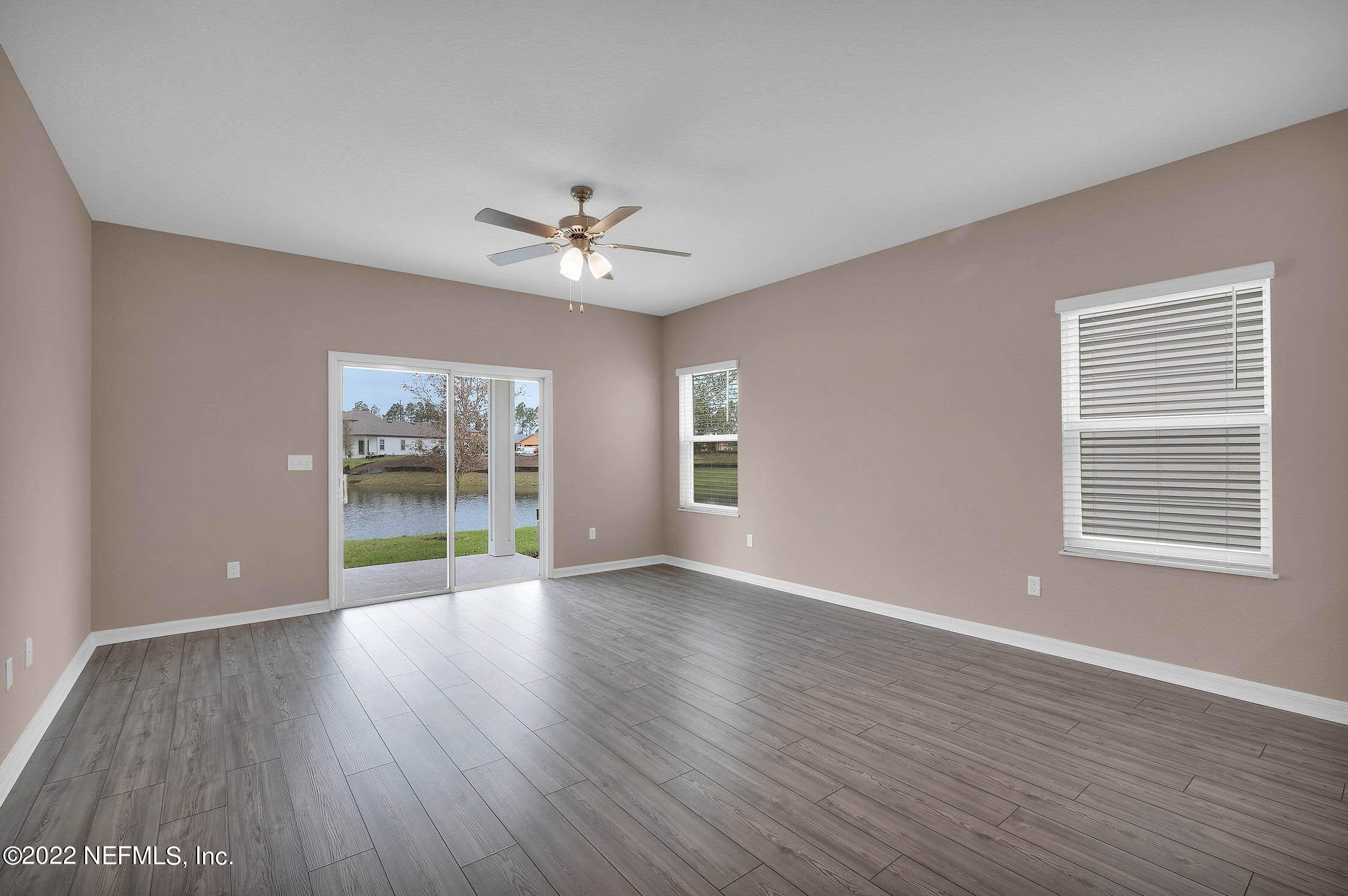 52 Falcon Ridge Road St. Augustine, FL 32084 - Photo 5 of 12 a view of an empty room with a window and wooden floor