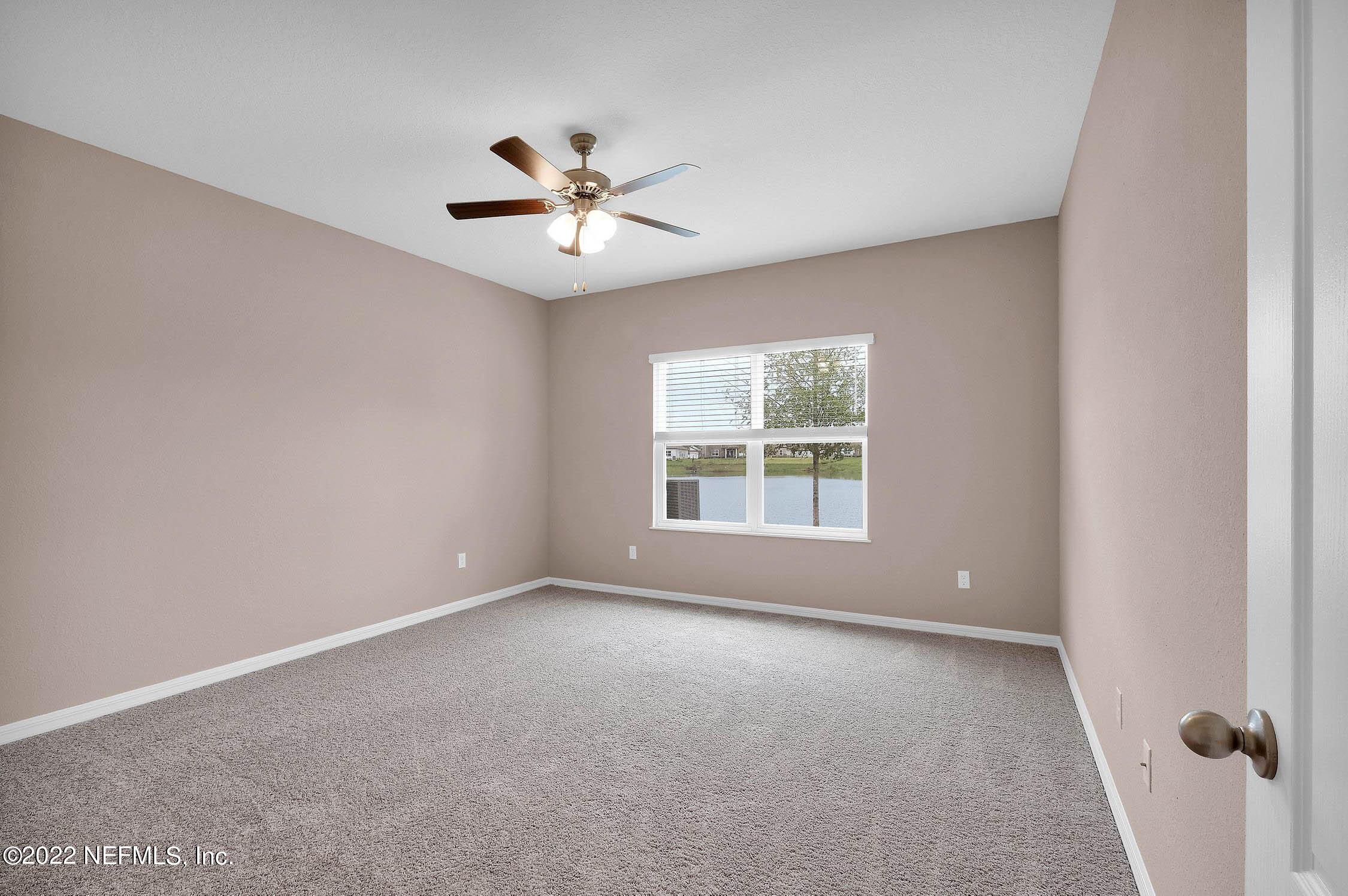 52 Falcon Ridge Road St. Augustine, FL 32084 - Photo 7 of 12 an empty room with a window and a fan