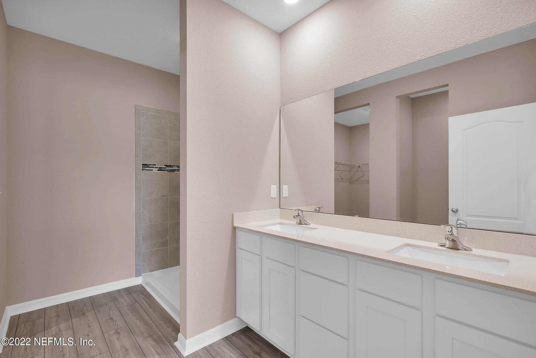 52 Falcon Ridge Road St. Augustine, FL 32084 - Photo 8 of 12 a bathroom with a double vanity sink and a mirror