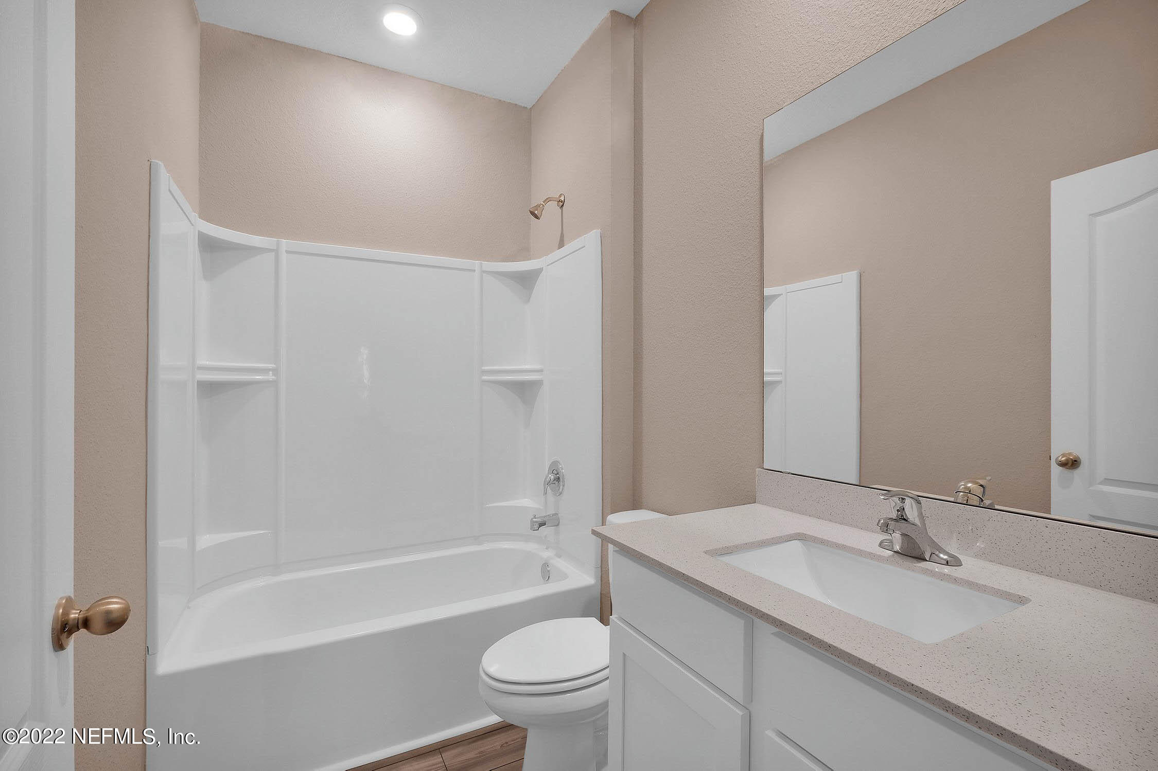 52 Falcon Ridge Road St. Augustine, FL 32084 - Photo 10 of 12 a bathroom with a granite countertop sink a toilet and bathtub