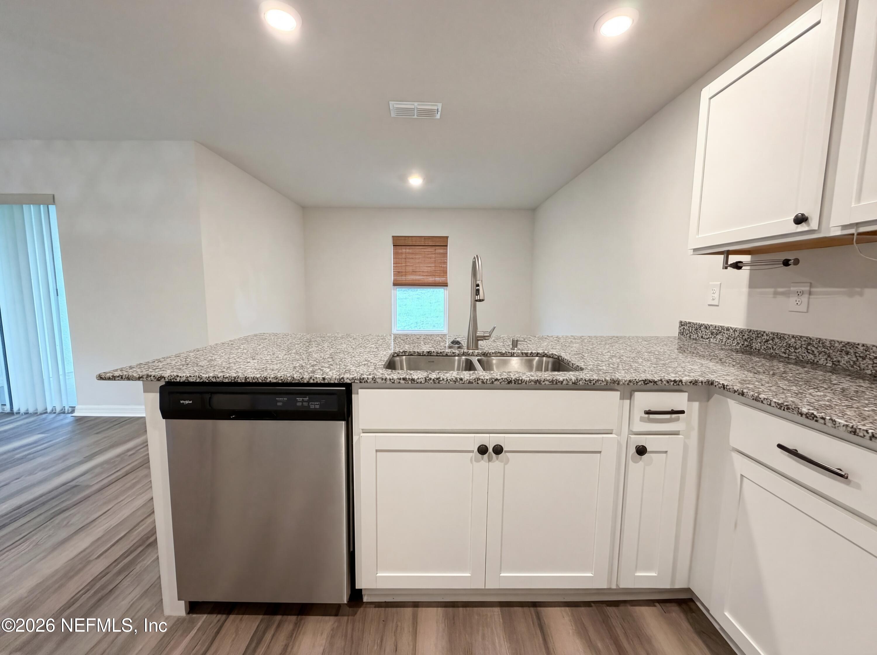 171 River Ridge Welaka, FL 32193 - Photo 11 of 17 a kitchen with granite countertop a sink cabinets and wooden floor