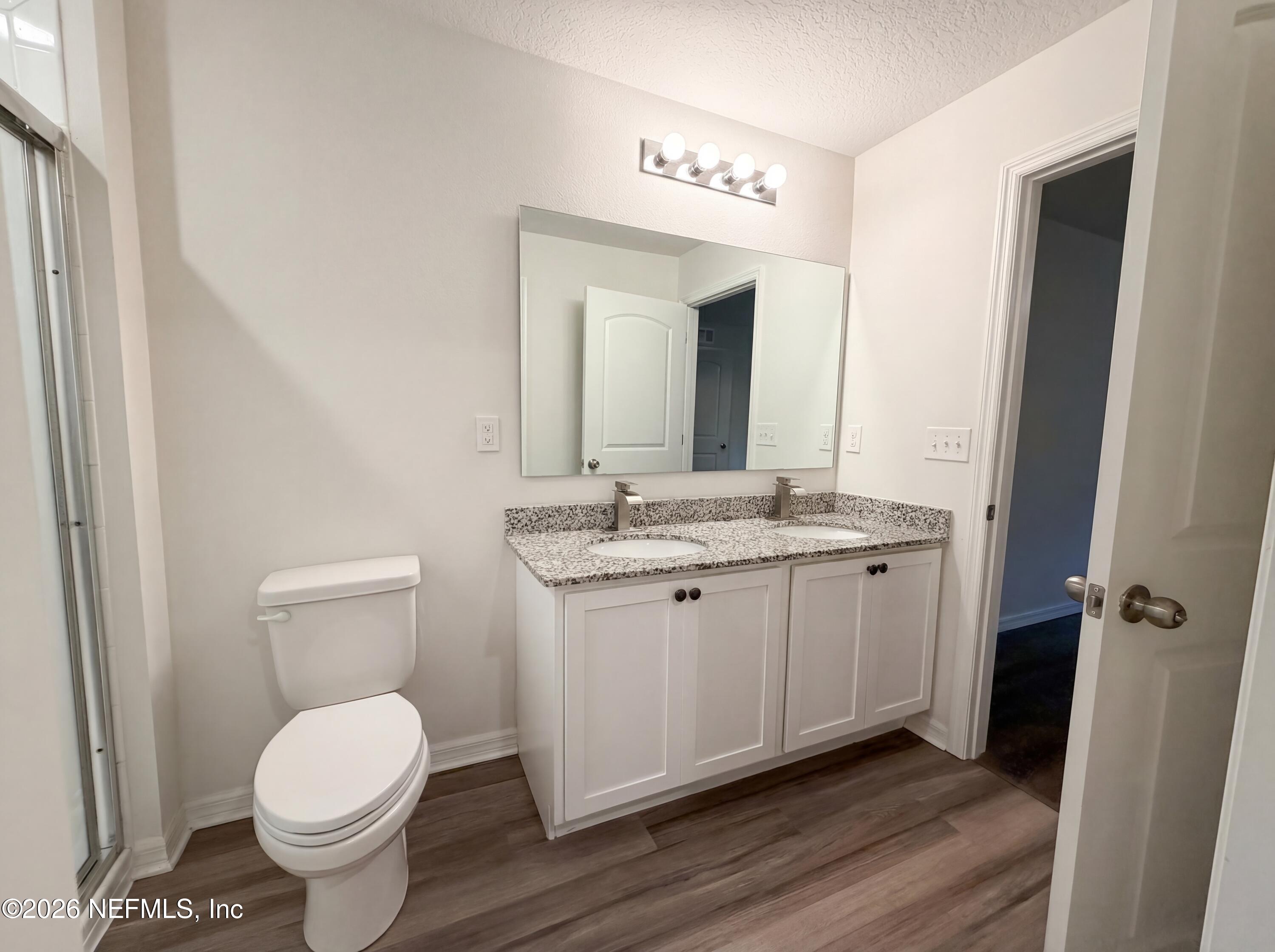 171 River Ridge Welaka, FL 32193 - Photo 16 of 17 a bathroom with a granite countertop toilet and a sink