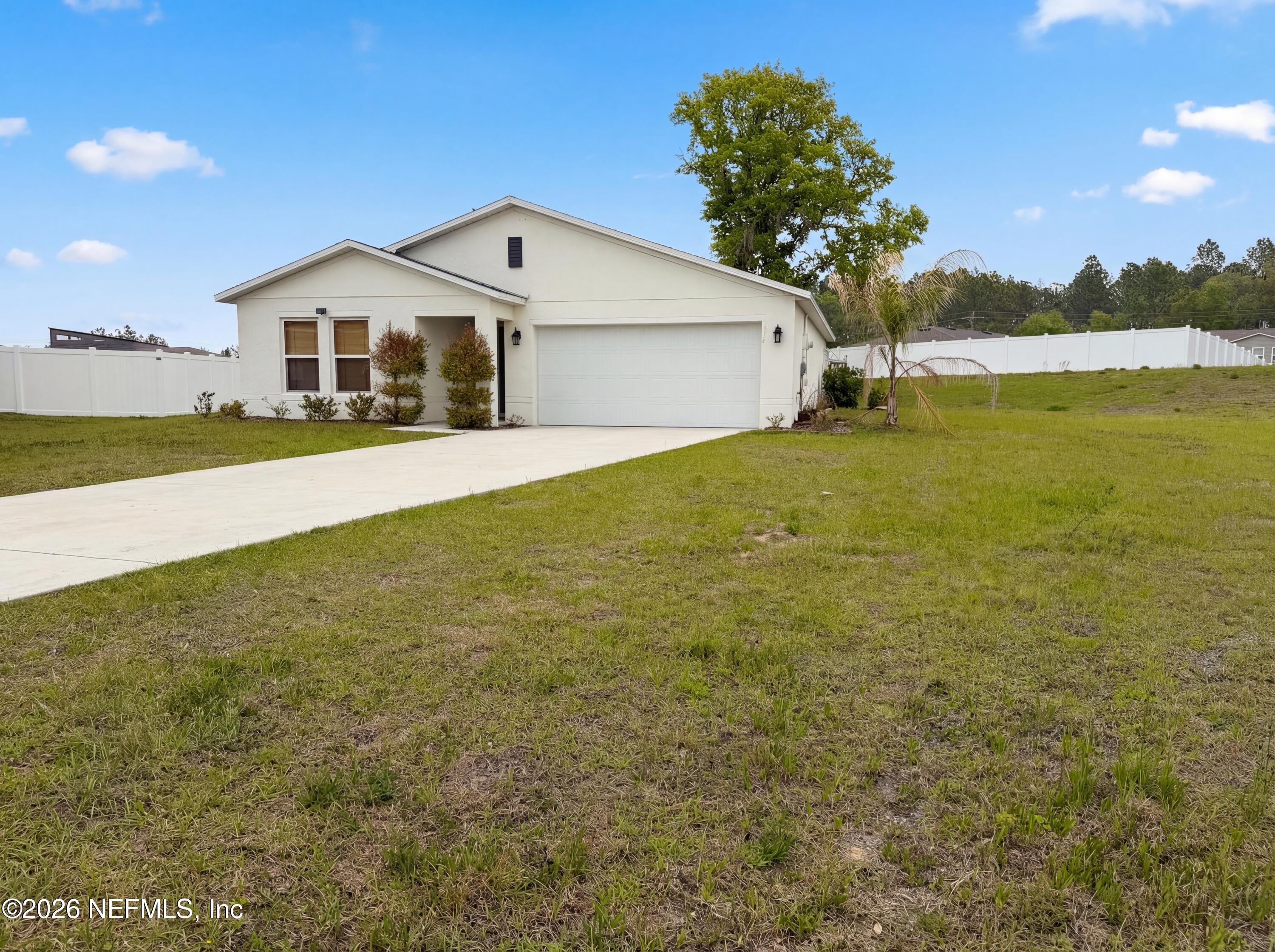 171 River Ridge Welaka, FL 32193 - Photo 6 of 17 a front view of a house with a yard and palm trees